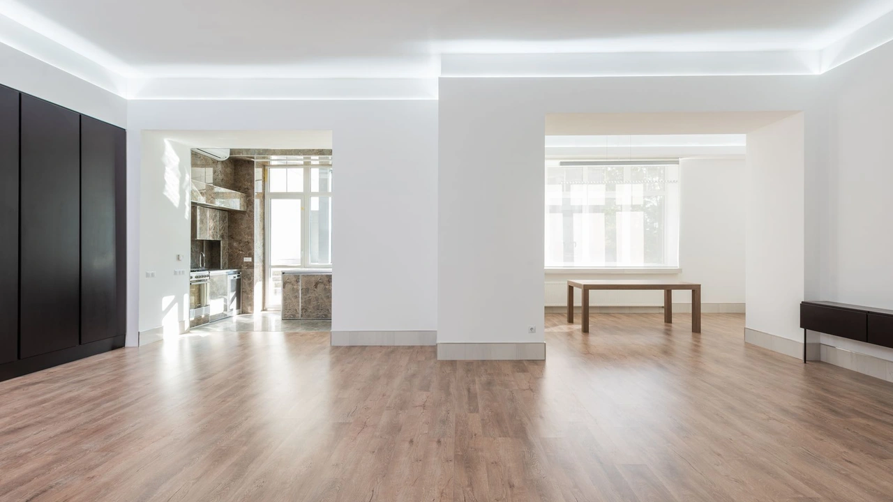 Professional technician buffing hardwood parquet flooring with a rotary machine
