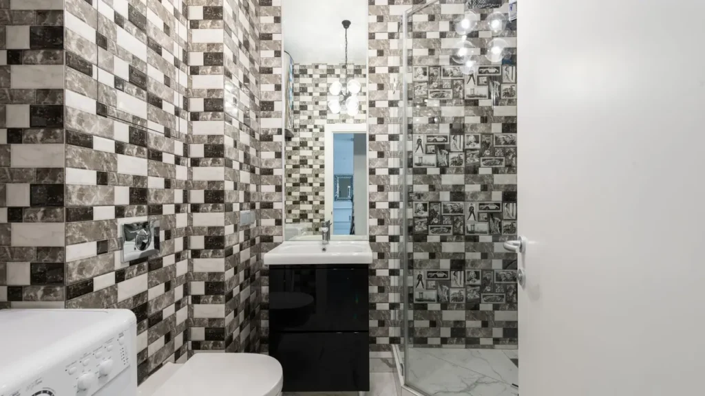 Professional cleaner steam cleaning tile grout lines in a luxury bathroom in Dubai