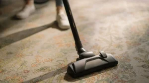 Professional cleaner vacuuming empty bedrooms before new furniture move-in