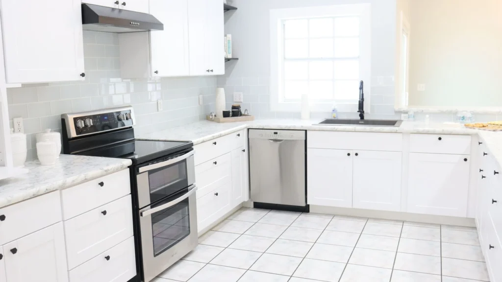 Professional housekeeper presenting a spotless clean kitchen after home cleaning service