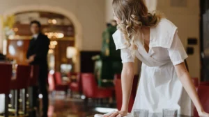 Professional maid tidying and cleaning up after a home dinner party