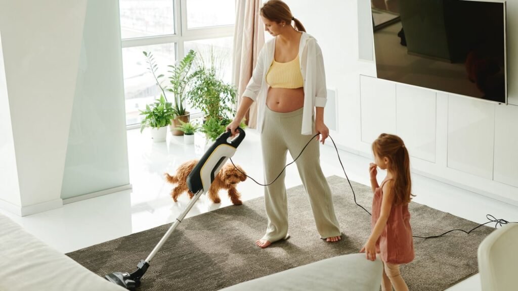 Professional housekeeper vacuuming a luxury home living room in Dubai