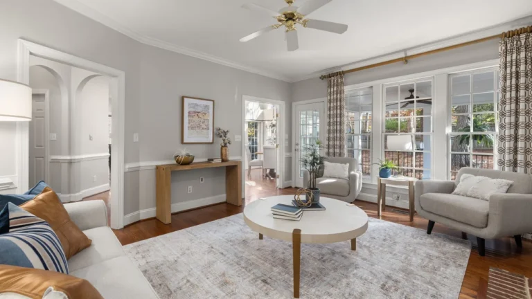 Clean organized family living room with fluffed pillows and swept floor after home cleaning