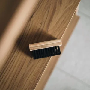 Mattress cleaner using a stain removal tool to scrub yellow spots in Dubai