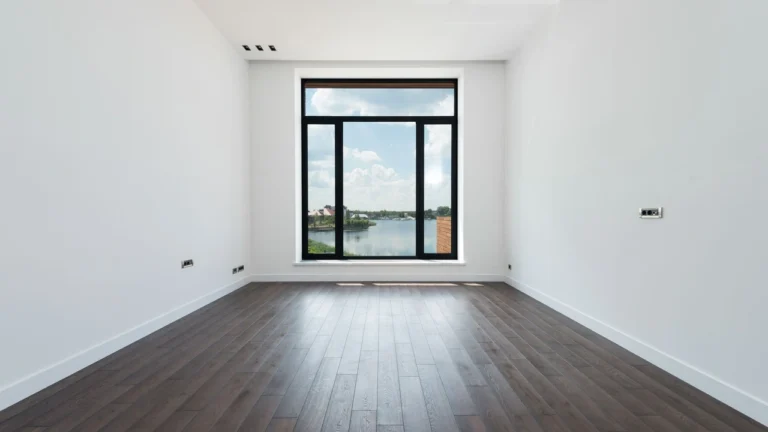 Vacated dusty apartment living room floor with dirt and scuff marks before cleaning