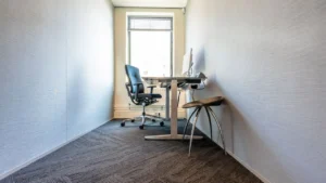 A carpet cleaning technician steam extracting office carpet floor tiles
