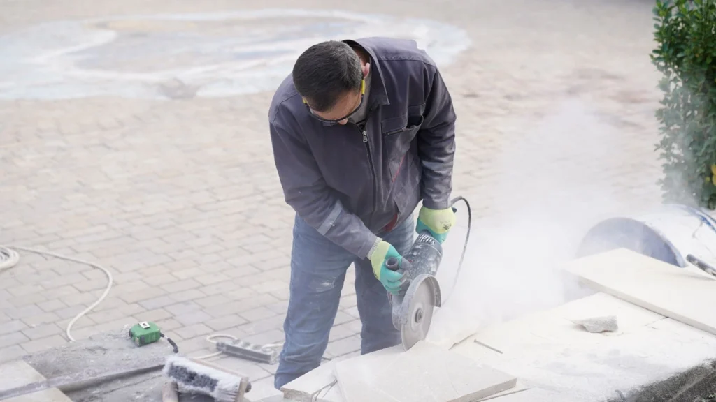 Professional pressure washing technician cleaning exterior marble patio tiles of a villa in Dubai