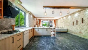 Professional kitchen cleaner steam degreasing large built-in cooker hood vents in a villa